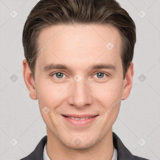 Joyful white young-adult male with short  brown hair and grey eyes