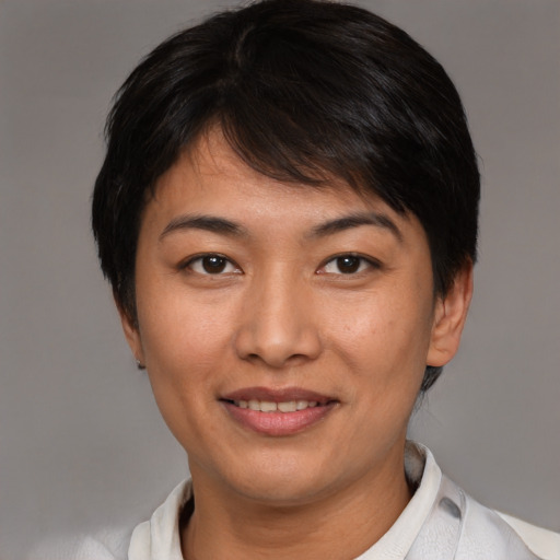 Joyful asian young-adult female with short  brown hair and brown eyes