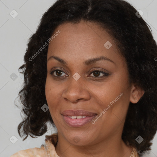 Joyful black adult female with medium  brown hair and brown eyes