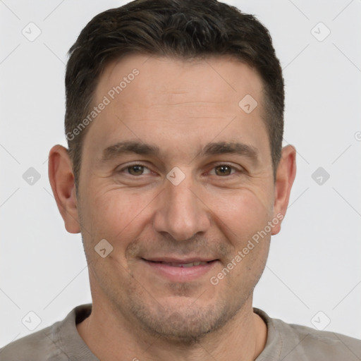 Joyful white adult male with short  brown hair and brown eyes