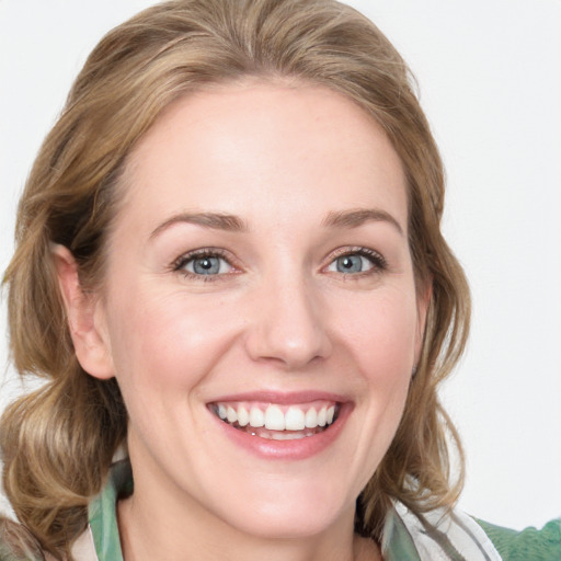 Joyful white young-adult female with medium  brown hair and blue eyes