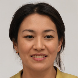 Joyful asian young-adult female with medium  brown hair and brown eyes