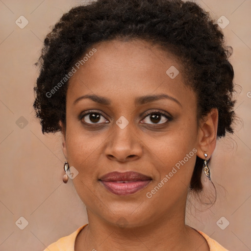 Joyful black young-adult female with long  brown hair and brown eyes