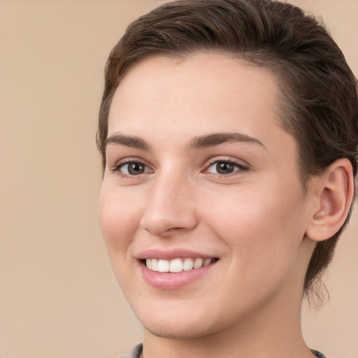 Joyful white young-adult female with medium  brown hair and grey eyes