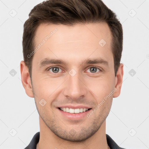 Joyful white young-adult male with short  brown hair and grey eyes