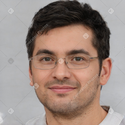 Joyful white adult male with short  black hair and brown eyes