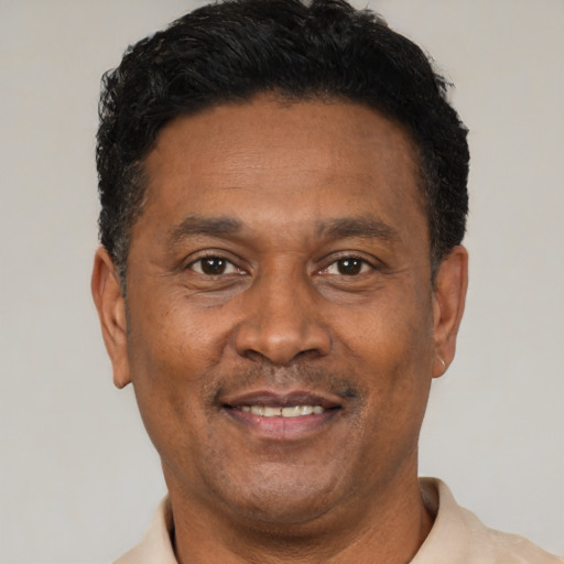 Joyful latino adult male with short  black hair and brown eyes