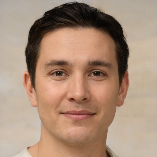 Joyful white young-adult male with short  brown hair and brown eyes