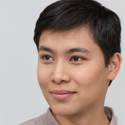 Joyful asian young-adult male with short  brown hair and brown eyes