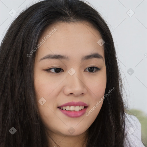 Joyful asian young-adult female with long  brown hair and brown eyes