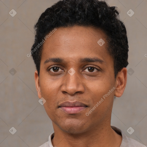 Joyful black young-adult male with short  black hair and brown eyes