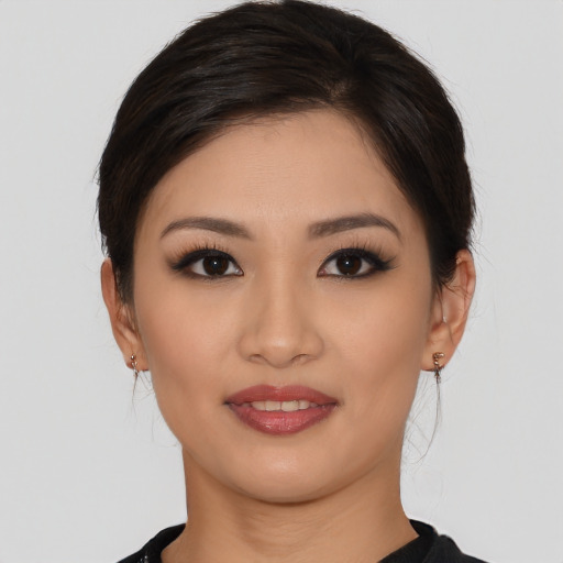 Joyful asian young-adult female with medium  brown hair and brown eyes