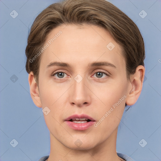 Joyful white young-adult female with short  brown hair and grey eyes