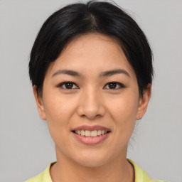 Joyful asian young-adult female with short  brown hair and brown eyes