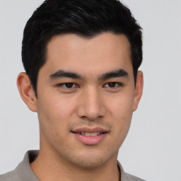 Joyful latino young-adult male with short  brown hair and brown eyes