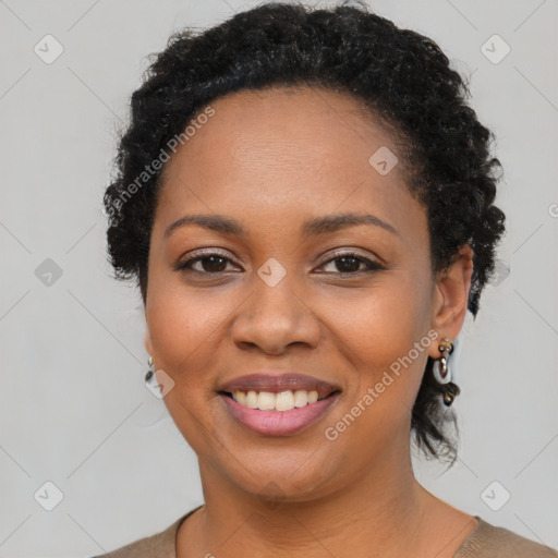 Joyful latino young-adult female with short  black hair and brown eyes