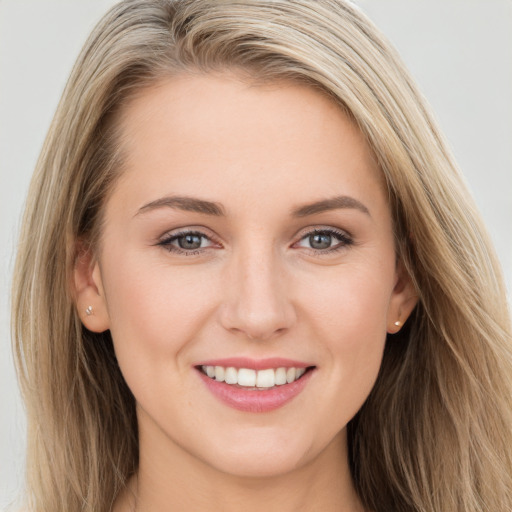 Joyful white young-adult female with long  brown hair and blue eyes