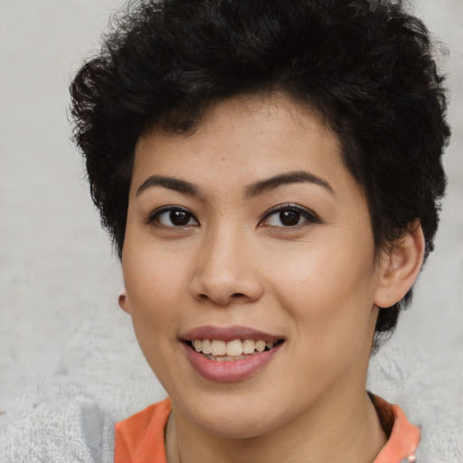 Joyful asian young-adult female with short  black hair and brown eyes