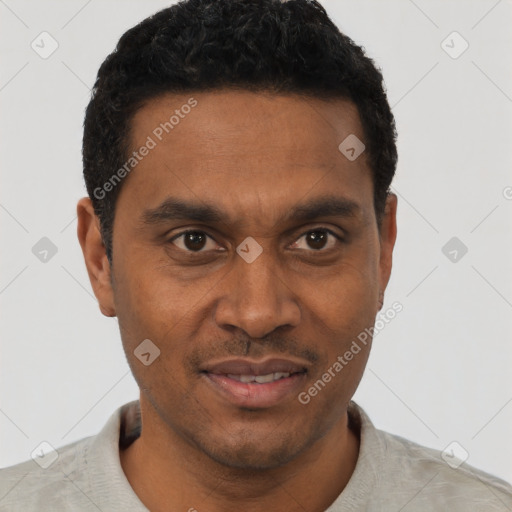 Joyful black young-adult male with short  black hair and brown eyes