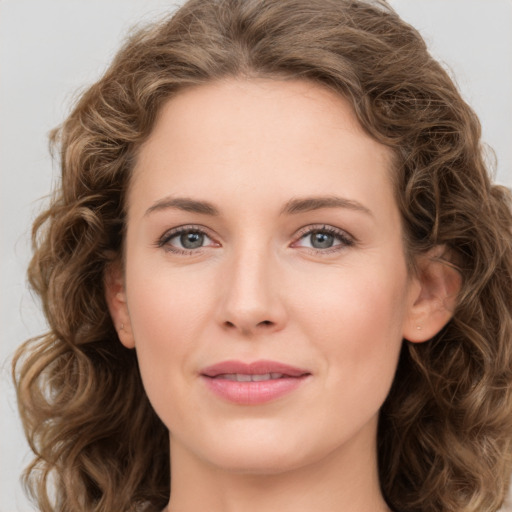 Joyful white young-adult female with long  brown hair and green eyes