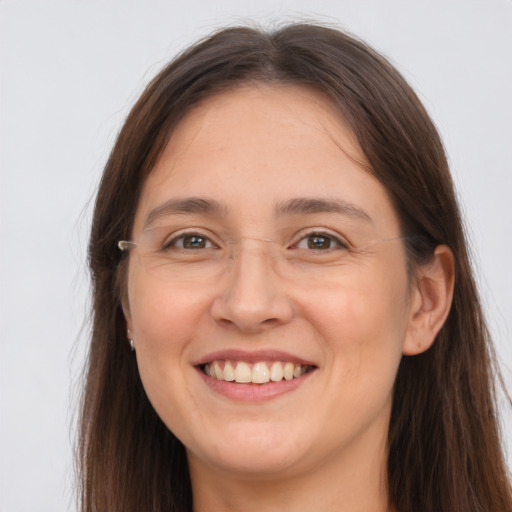 Joyful white young-adult female with long  brown hair and grey eyes