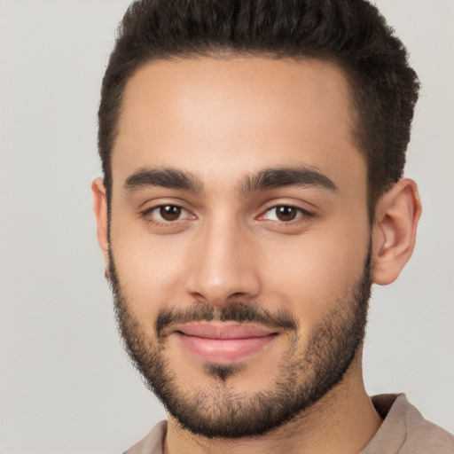 Joyful white young-adult male with short  brown hair and brown eyes