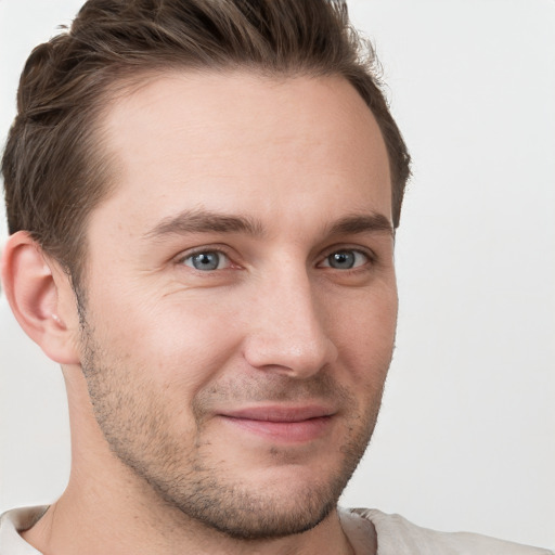 Joyful white young-adult male with short  brown hair and grey eyes