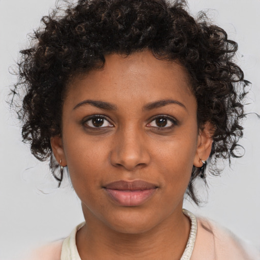 Joyful black young-adult female with medium  brown hair and brown eyes