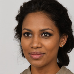 Joyful black young-adult female with medium  brown hair and brown eyes