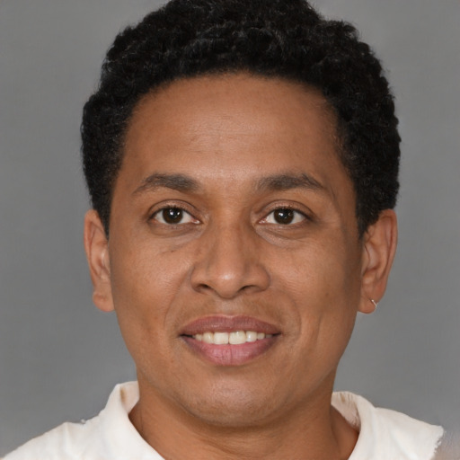 Joyful latino adult male with short  brown hair and brown eyes