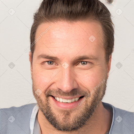 Joyful white adult male with short  brown hair and brown eyes