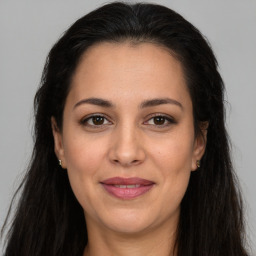 Joyful white adult female with long  brown hair and brown eyes