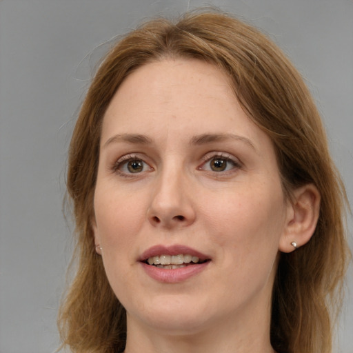 Joyful white adult female with medium  brown hair and brown eyes