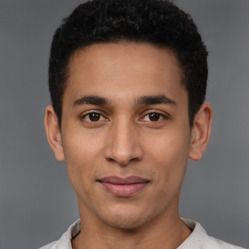 Joyful latino young-adult male with short  brown hair and brown eyes