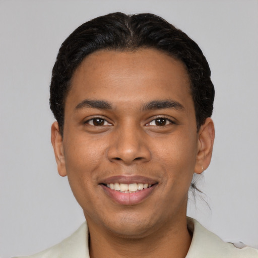 Joyful latino young-adult male with short  black hair and brown eyes
