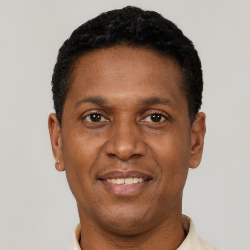 Joyful latino adult male with short  black hair and brown eyes
