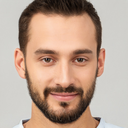 Joyful white young-adult male with short  brown hair and brown eyes