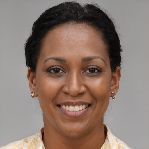 Joyful latino adult female with short  brown hair and brown eyes