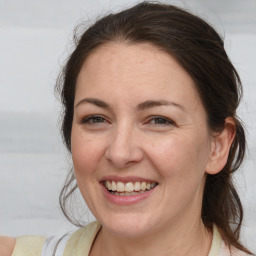 Joyful white adult female with medium  brown hair and brown eyes