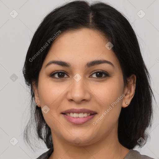 Joyful latino young-adult female with medium  brown hair and brown eyes