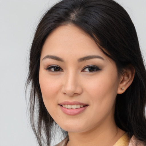 Joyful asian young-adult female with long  brown hair and brown eyes