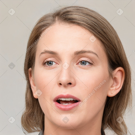 Joyful white young-adult female with medium  brown hair and blue eyes