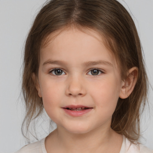 Joyful white child female with medium  brown hair and brown eyes