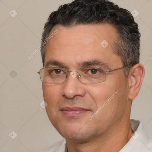 Joyful white adult male with short  black hair and brown eyes