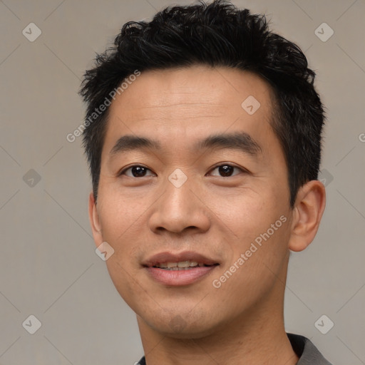 Joyful asian young-adult male with short  black hair and brown eyes