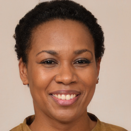 Joyful black adult female with short  brown hair and brown eyes