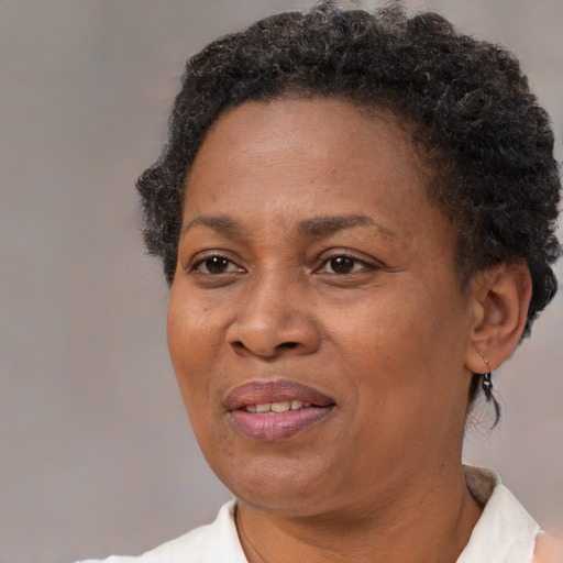 Joyful black adult female with short  brown hair and brown eyes