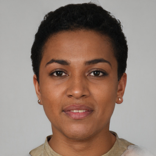 Joyful black young-adult female with short  black hair and brown eyes
