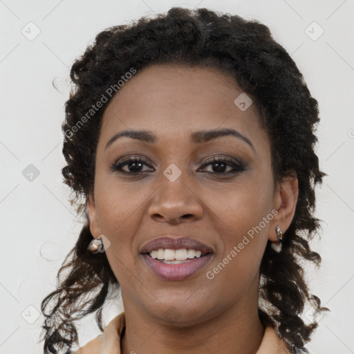 Joyful black young-adult female with long  brown hair and brown eyes
