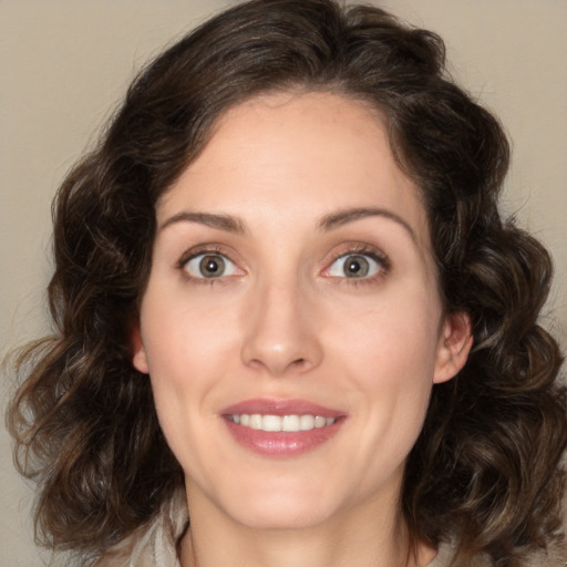 Joyful white young-adult female with medium  brown hair and green eyes